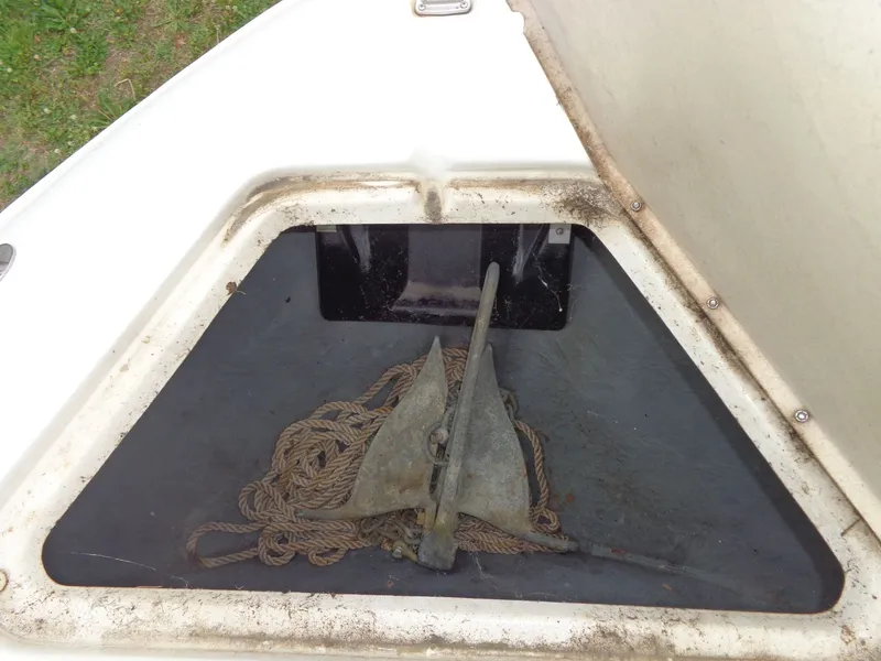 Slide: The Image of Anchor compartment of 1999 Sea Ray Express Cruiser with anchor and rope. - 16