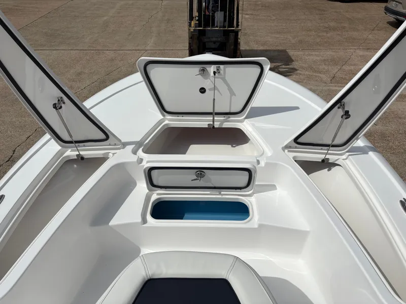 Slide: The Image of 2026 Tidewater 2110 Bay Max boat with open storage compartments. - 13