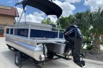 Slide: The Image of 2026 Sun Tracker Bass Buggy 16 XL Select pontoon boat with Mercury outboard motor. - 3
