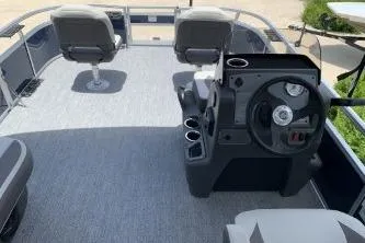 Slide: The Image of 2026 Sun Tracker Bass Buggy 16 XL Select pontoon boat interior with steering console and seating. - 8