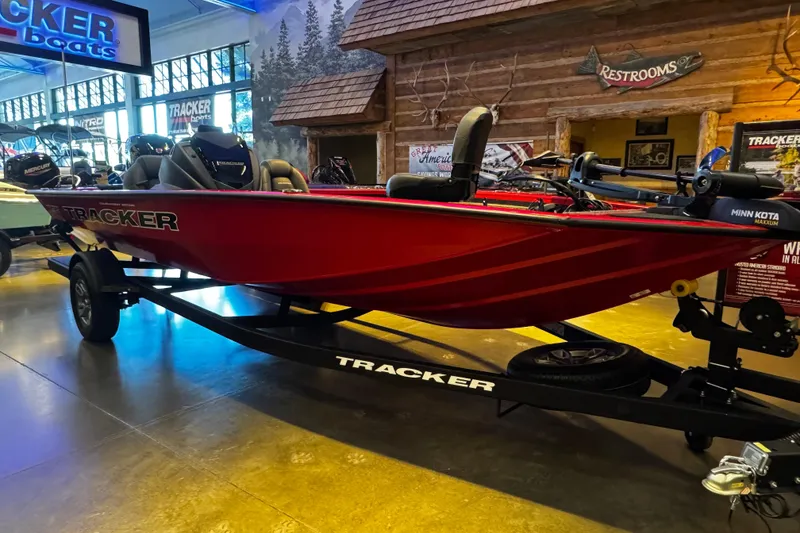 The Image of Red 2026 Tracker Pro Team 195 boat displayed indoors on a trailer. - 0