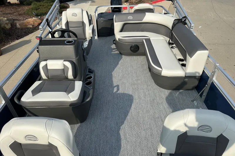 Slide: The Image of 2026 Sun Tracker Bass Buggy 18 DLX pontoon boat interior with seating and steering console. - 2