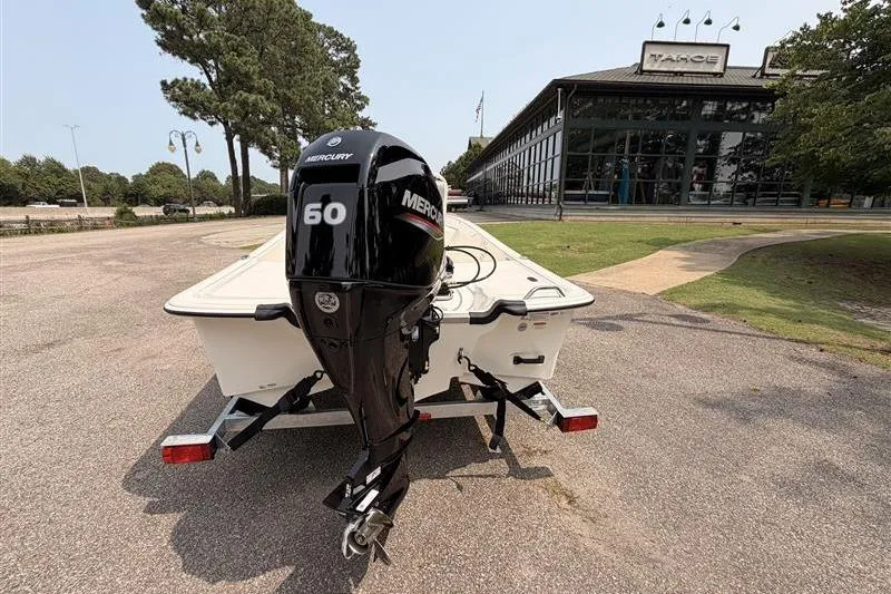 Slide: The Image of 2026 Mako Pro Skiff 17 CC with Mercury 60 engine on trailer, parked outdoors. - 3