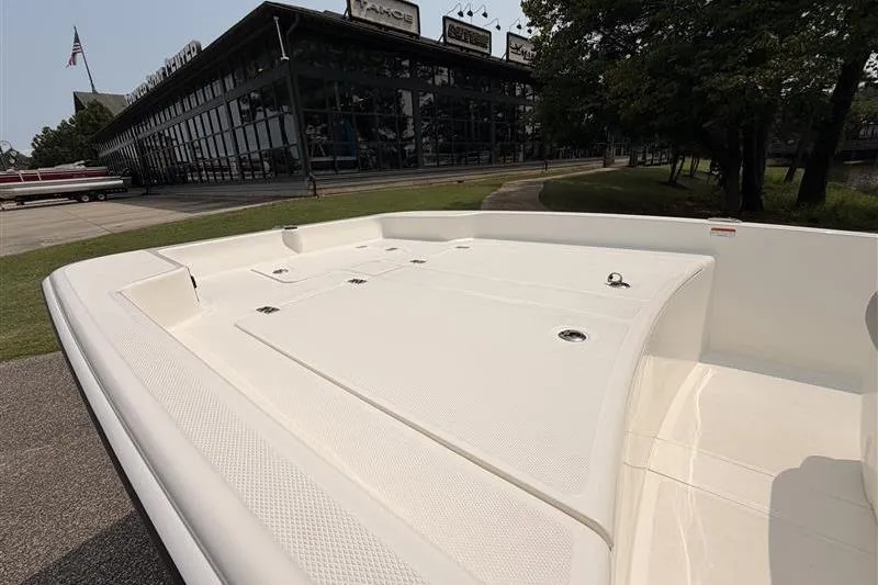 Slide: The Image of 2026 Mako Pro Skiff 17 CC boat displayed outside a showroom. - 6