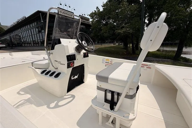 Slide: The Image of 2026 Mako Pro Skiff 17 CC boat interior with steering console and seating. - 11