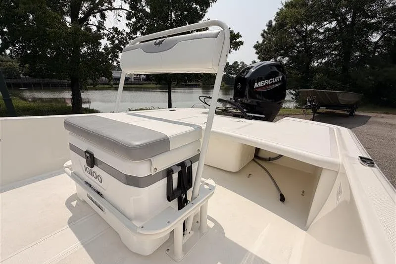 Slide: The Image of 2026 Mako Pro Skiff 17 CC boat with Mercury engine and Igloo cooler seat. - 12