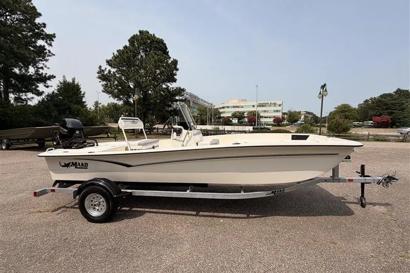 Slide: The Image of 2026 Mako Pro Skiff 17 CC boat on trailer, parked outdoors. - 4