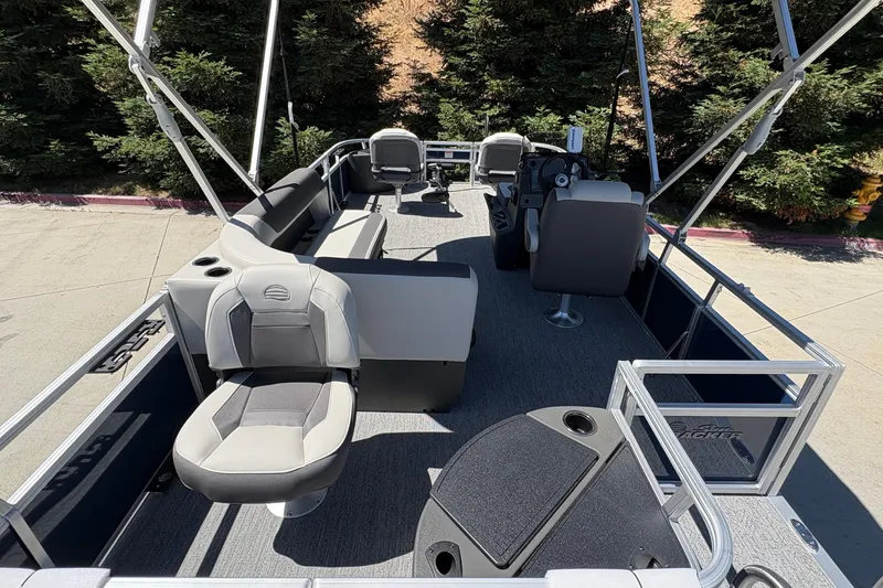 Slide: The Image of 2026 Sun Tracker Bass Buggy 18 DLX pontoon boat interior with seating and helm. - 12