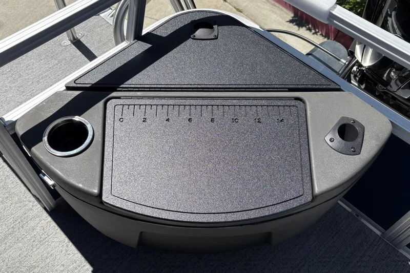 Slide: The Image of 2026 Sun Tracker Bass Buggy 18 DLX boat deck with integrated ruler and cup holders. - 26