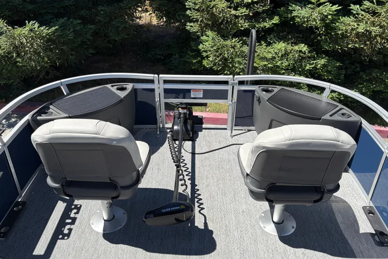 Slide: The Image of 2026 Sun Tracker Bass Buggy 18 DLX pontoon boat interior with two seats and control panel. - 11