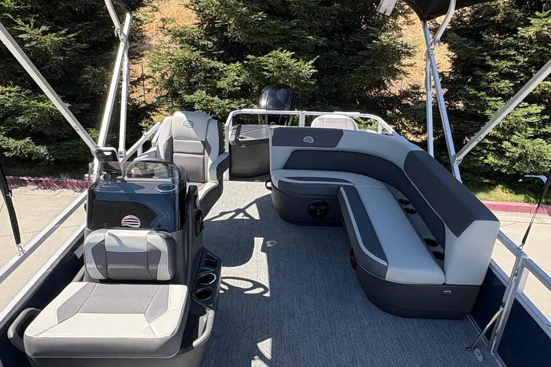 Slide: The Image of 2026 Sun Tracker Bass Buggy 18 DLX pontoon boat interior with seating and helm. - 13