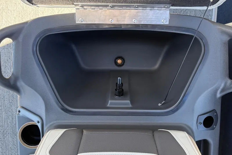 Slide: The Image of Storage compartment of 2026 Sun Tracker Bass Buggy 18 DLX boat, featuring cup holders. - 18