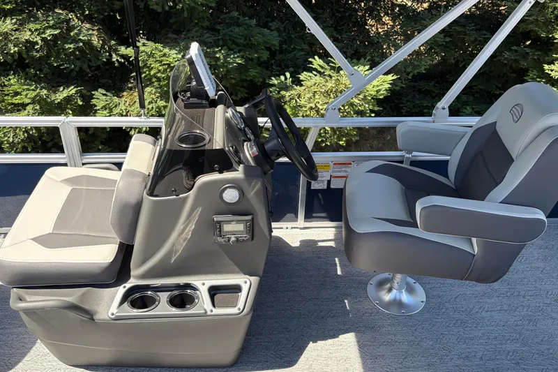 Slide: The Image of 2026 Sun Tracker Bass Buggy 18 DLX boat interior with steering console and seating. - 16
