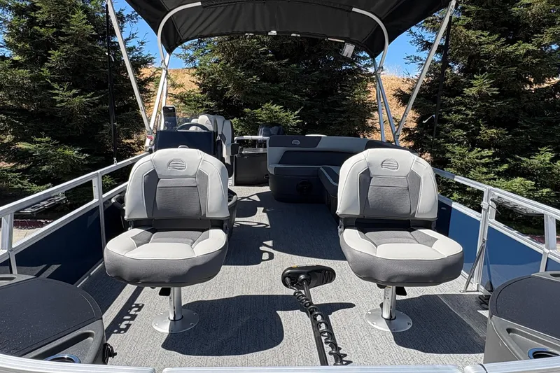 Slide: The Image of 2026 Sun Tracker Bass Buggy 18 DLX pontoon boat interior with seating and canopy. - 15