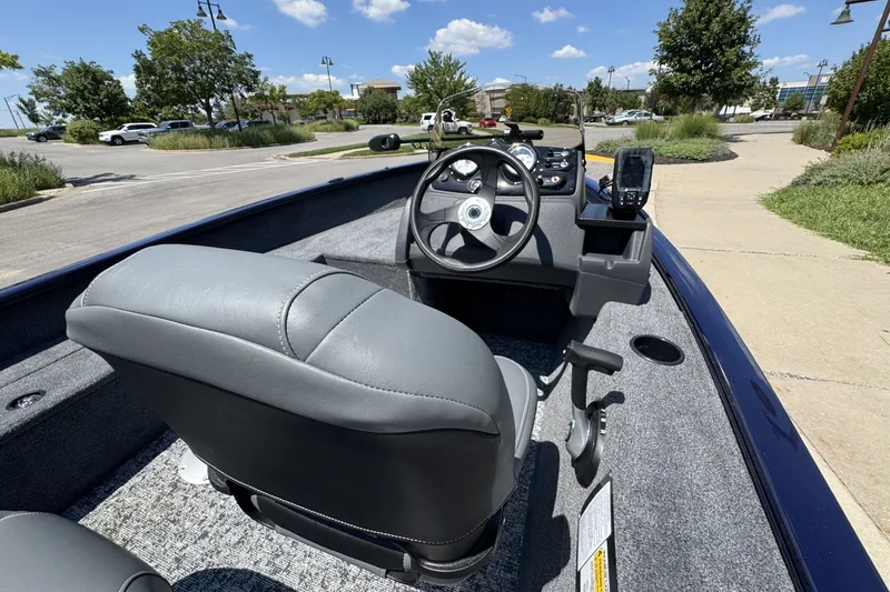 Slide: The Image of 2026 Tracker Super Guide V-16 SC boat interior with steering wheel and seating. - 56
