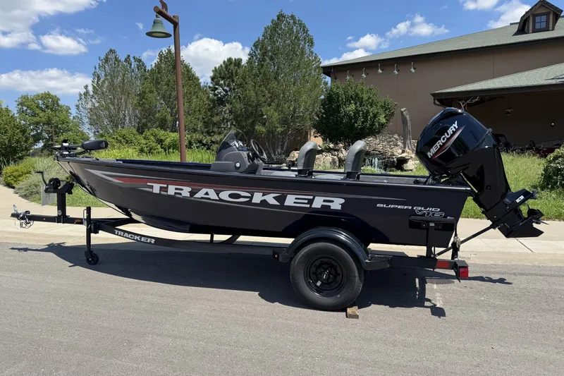 The Image of 2026 Tracker Super Guide V-16 SC boat on trailer, parked outdoors. - 0