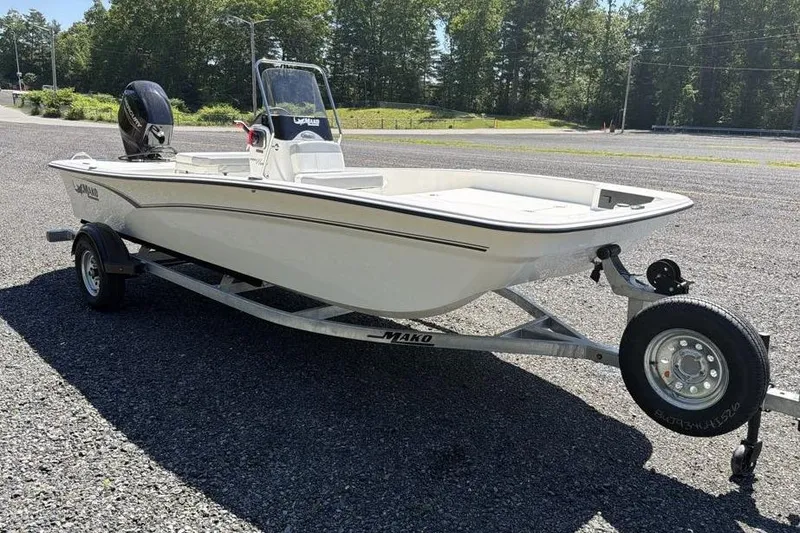 Slide: The Image of 2026 Mako Pro Skiff 17 CC boat on trailer, parked outdoors. - 5