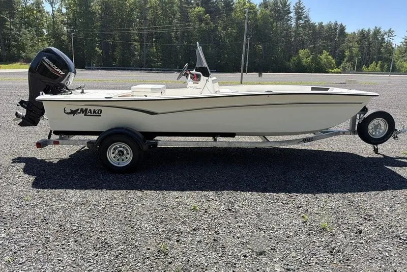 Slide: The Image of 2026 Mako Pro Skiff 17 CC boat on trailer, parked outdoors. - 2
