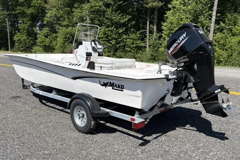 Slide: The Image of 2026 Mako Pro Skiff 17 CC boat on trailer, parked outdoors. - 3