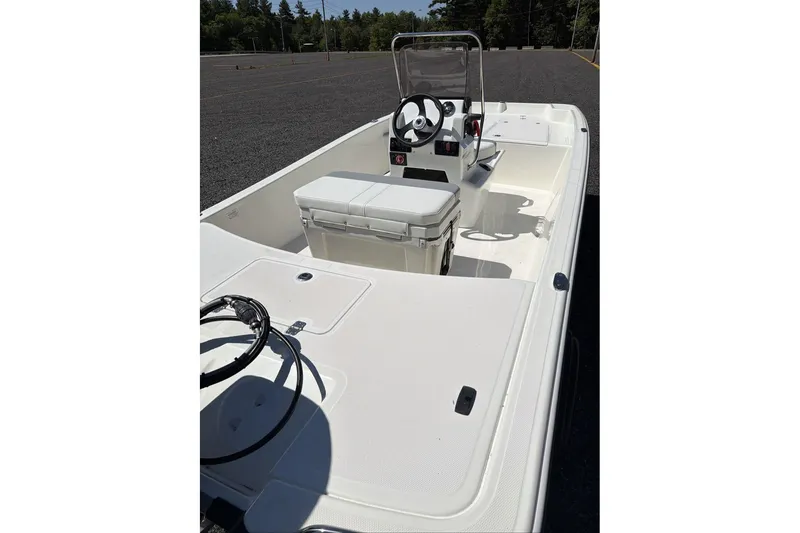 Slide: The Image of 2026 Mako Pro Skiff 17 CC boat interior with steering console and seating. - 8