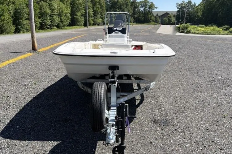 Slide: The Image of 2026 Mako Pro Skiff 17 CC on trailer, parked on a sunny road. - 6