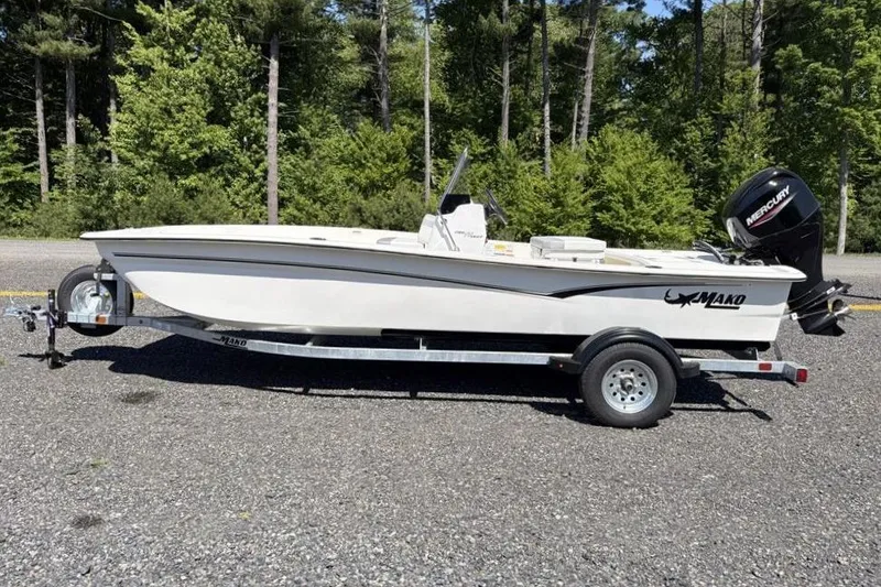 Slide: The Image of 2026 Mako Pro Skiff 17 CC boat on trailer, parked outdoors. - 1