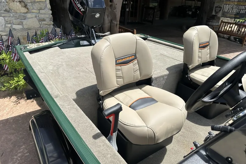 Slide: The Image of 2026 Tracker Bass Tracker Classic Limited boat interior with beige seats and steering wheel. - 7