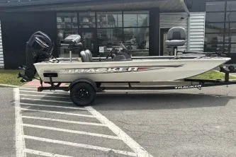 The Image of 2026 Tracker Pro 170 boat parked outside a building on a trailer. - 0