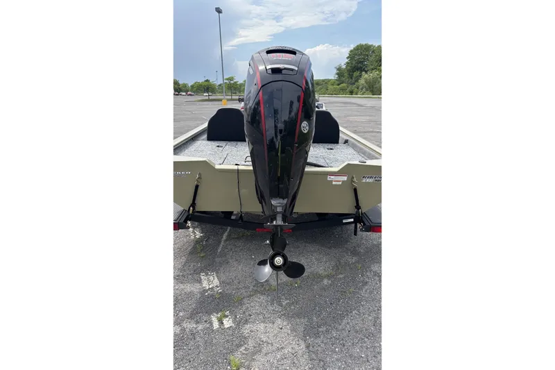 Slide: The Image of 2026 Tracker Pro Team 190 boat with outboard motor in parking lot. - 2