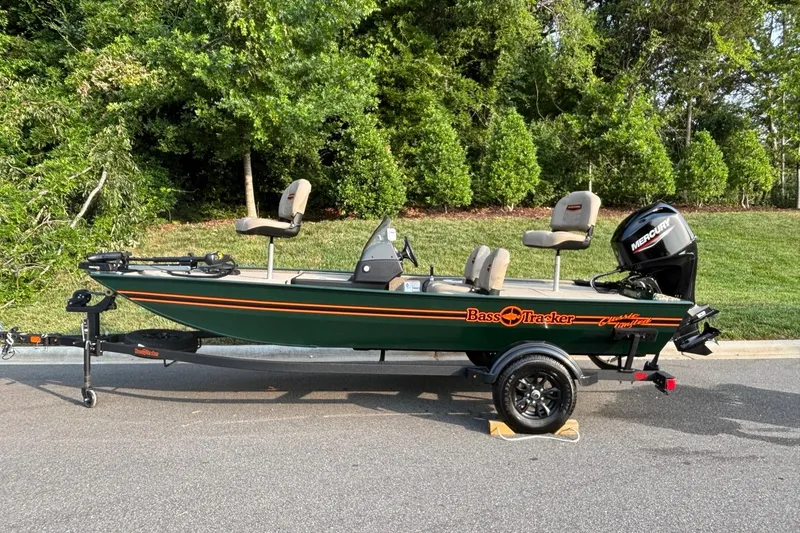The Image of 2026 Tracker Bass Tracker Classic Limited boat on trailer, parked outdoors. - 0