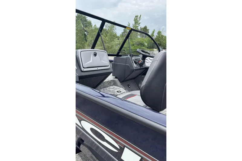 Slide: The Image of 2026 Tracker Pro Guide V-175 WT boat interior with steering console and seating. - 4