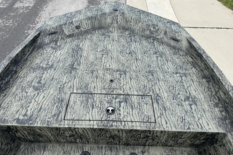 Slide: The Image of 2026 Tracker Grizzly 1860 CC boat with camouflage pattern on a concrete surface. - 18