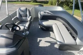 Slide: The Image of 2026 Sun Tracker Party Barge 18 DLX interior with seating and steering wheel. - 4