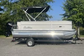 The Image of 2026 Sun Tracker Party Barge 18 DLX pontoon boat with canopy on trailer. - 0