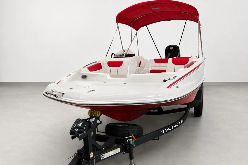 Slide: The Image of 2026 Tahoe 1950 boat with red canopy and white interior on trailer. - 1