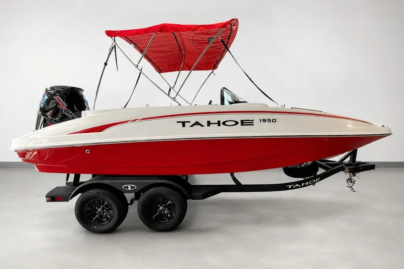 The Image of 2026 Tahoe 1950 boat with red canopy on trailer in showroom. - 0
