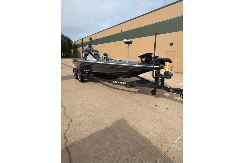 Slide: The Image of 2026 Nitro Z20 XL boat on trailer, parked outside a building. - 11