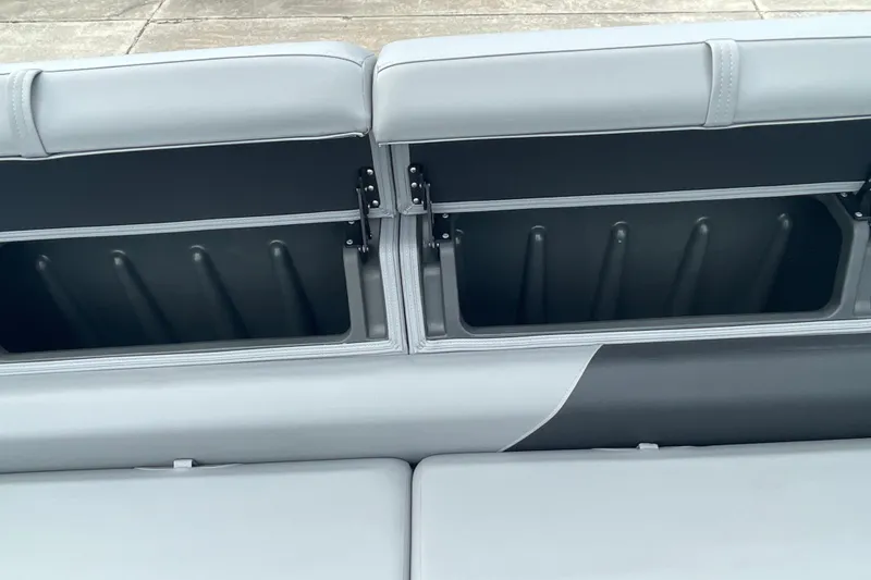 Slide: The Image of 2026 Sun Tracker Party Barge 24 XP3 seating with open storage compartments. - 34