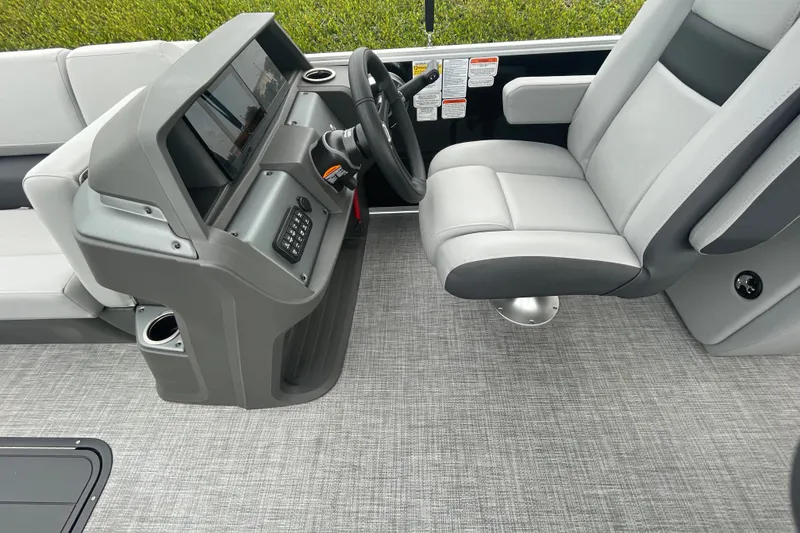 Slide: The Image of 2026 Sun Tracker Party Barge 24 XP3 helm with modern steering and seating. - 11