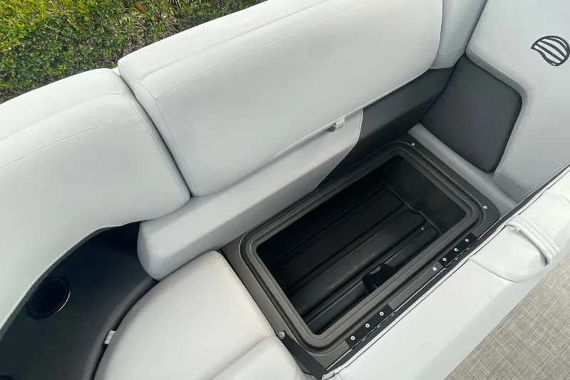 Slide: The Image of 2026 Sun Tracker Party Barge 24 XP3 interior storage compartment with cushioned seating. - 27