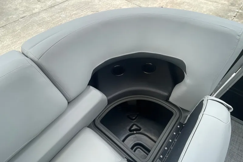 Slide: The Image of 2026 Sun Tracker Party Barge 24 XP3, gray seating with integrated storage and cup holders. - 30