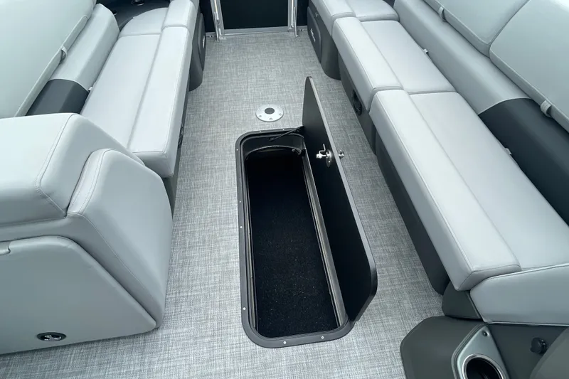 Slide: The Image of Interior of 2026 Sun Tracker Party Barge 24 XP3 with open storage compartment. - 25