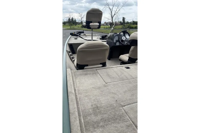 Slide: The Image of 2026 Tracker Bass Tracker Classic Limited boat interior with beige seating and dashboard view. - 4