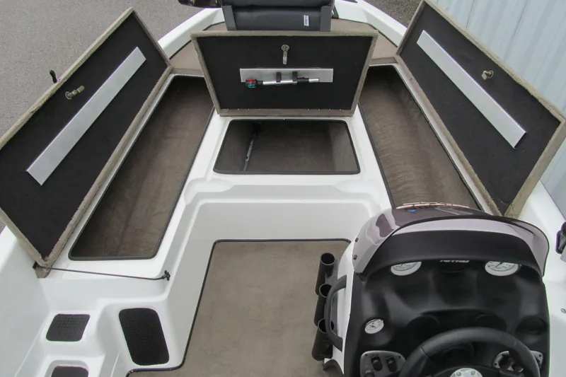 Slide: The Image of 2007 Nitro NX 750 SC boat interior with open storage compartments and steering console. - 7