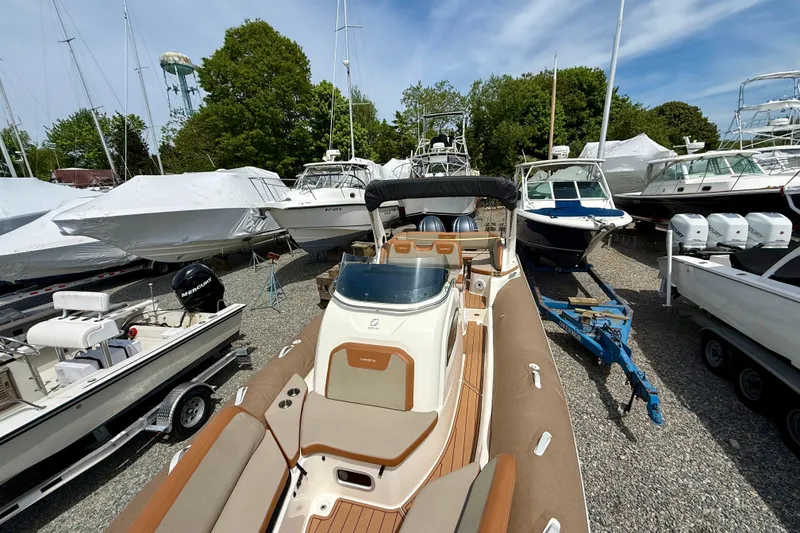 Slide: The Image of 2024 Zodiac Medline 9 boat displayed in a marina with other vessels. - 10