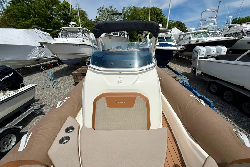 Slide: The Image of 2024 Zodiac Medline 9 boat in a marina, surrounded by other vessels. - 11