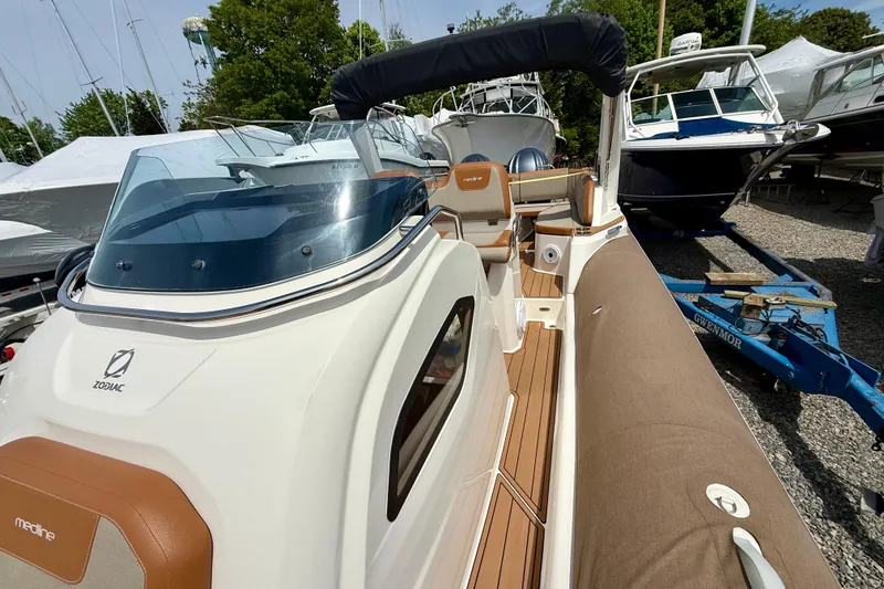 Slide: The Image of 2024 Zodiac Medline 9 boat with sleek design, docked among other vessels. - 12