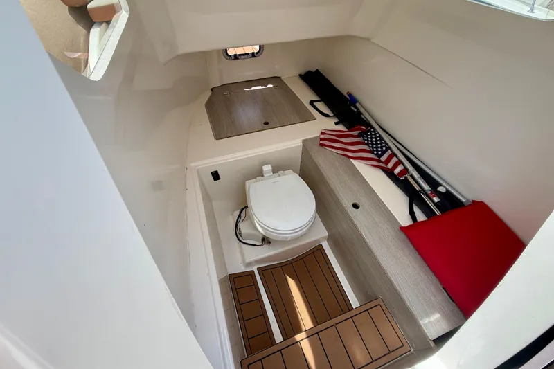 Slide: The Image of 2024 Zodiac Medline 9 cabin interior with toilet, storage, and American flag. - 15