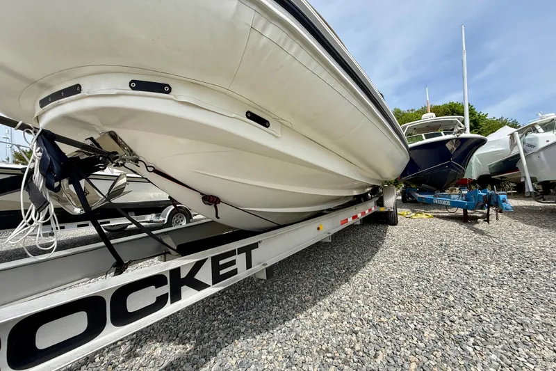 Slide: The Image of 2024 Zodiac Medline 9 boat on trailer, parked on gravel lot under clear sky. - 2