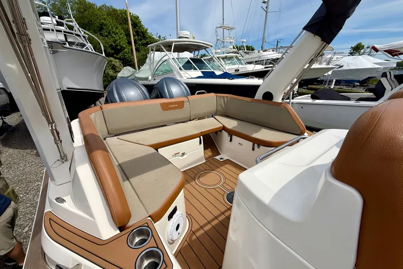 Slide: The Image of 2024 Zodiac Medline 9 boat interior with cushioned seating and dual outboard motors. - 22